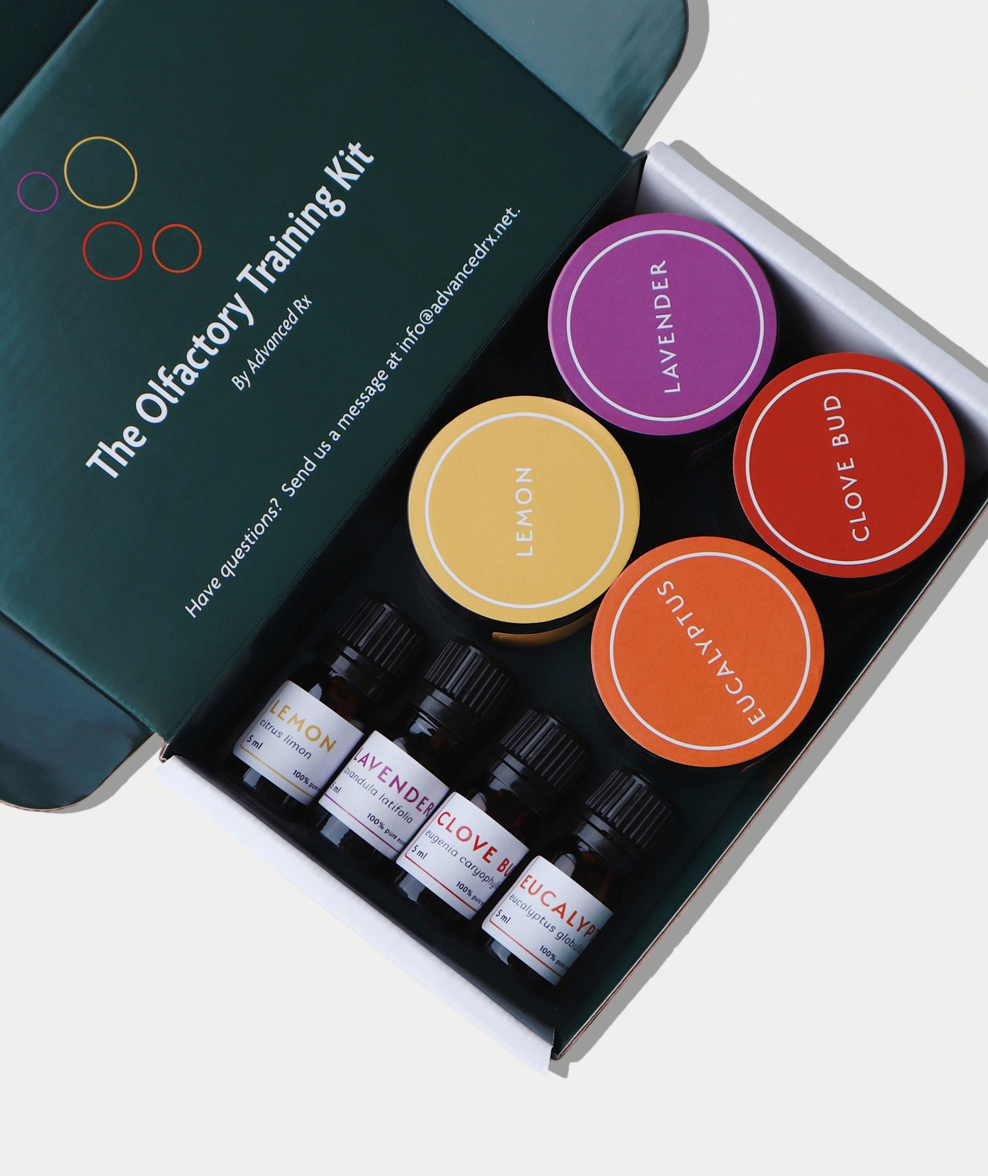 The Olfactory Training Kit: pharmacy-assembled smell training kit with four GC/MS-verified essential oils (lavender, lemon, clove bud, eucalyptus) in amber glass bottles, made at Advanced Rx, a licensed compounding pharmacy.